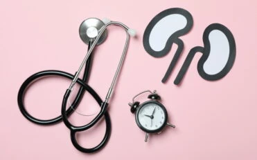 Alarm clock, paper kidneys and stethoscope on pink background Alarm clock, paper kidneys and stethoscope on pink background